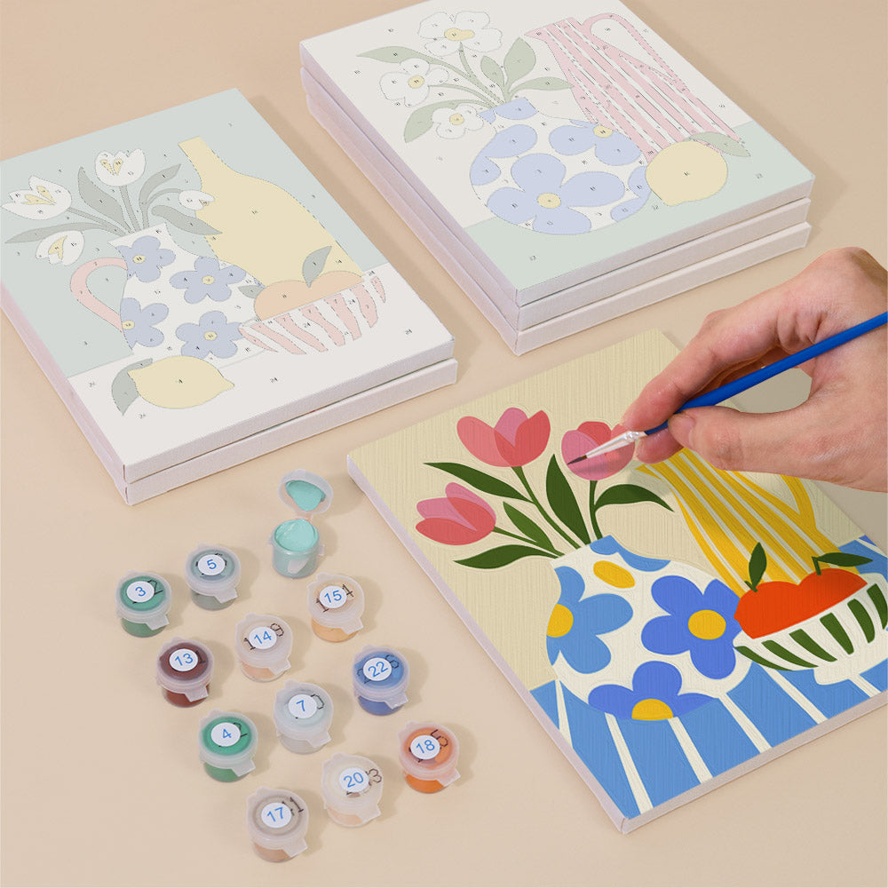 Painting one of the Sunny Kitchen Table designs next to a stack of mini canvases