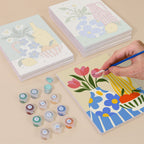 Painting one of the Sunny Kitchen Table designs next to a stack of mini canvases
