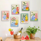 Six finished Sunny Kitchen Table mini paintings hung on a wall above a table