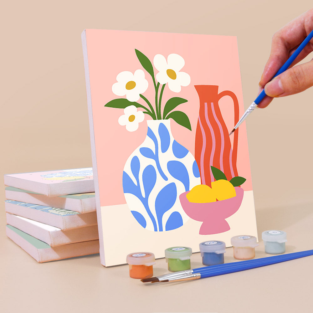 Painting a Sunny Kitchen Table mini canvas propped up beside numbered acrylic paints