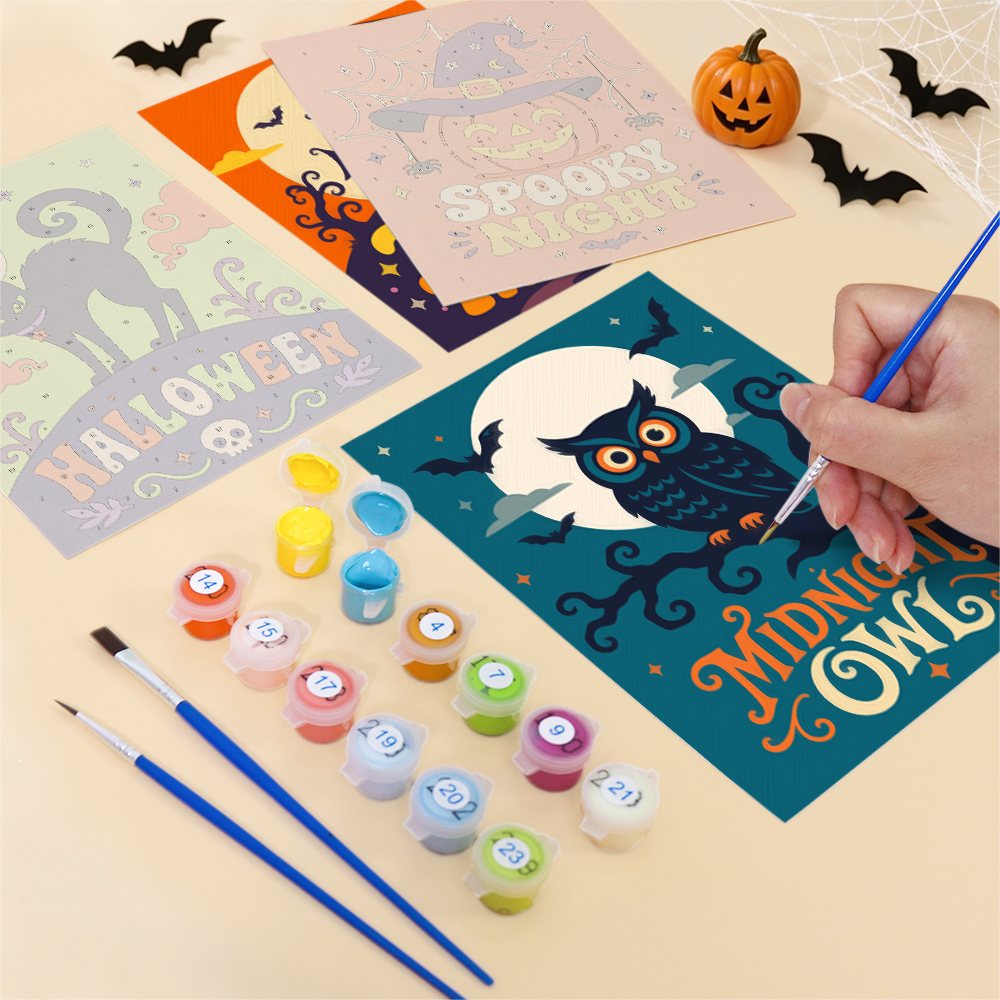 Filling in a Sweet Frights mini canvas with numbered acrylic paints and a fine brush