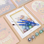 Numbered paint pots and brushes on a pre-stretched Sweet Frights mini canvas