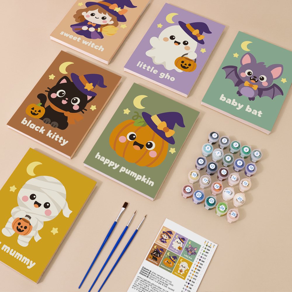 Painting one of the Sweet Little Spooks designs next to a stack of mini canvases