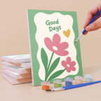 Painting a Sweet Sayings mini canvas propped up beside numbered acrylic paints