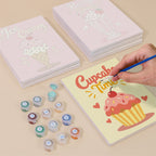 Painting one of the Sweet Shop designs next to a stack of mini canvases