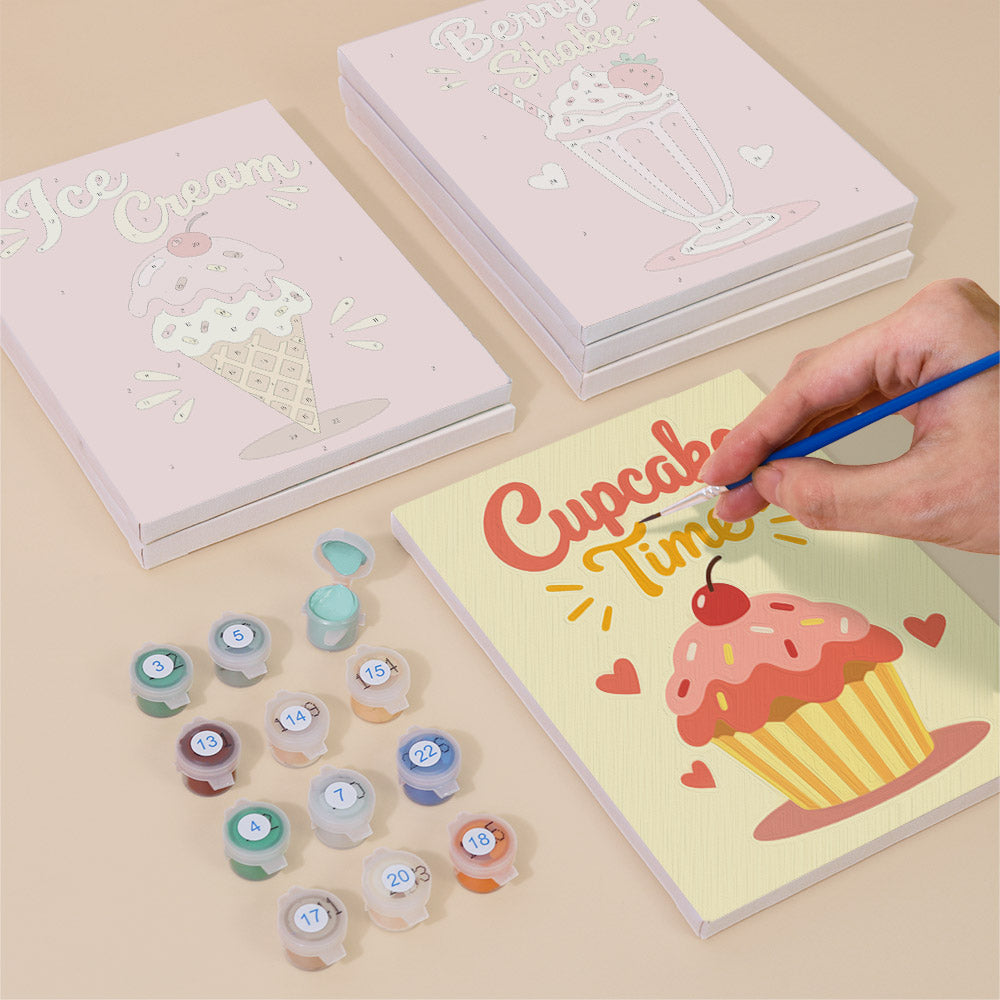 Painting one of the Sweet Shop designs next to a stack of mini canvases