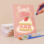 Painting a Sweet Shop mini canvas propped up beside numbered acrylic paints