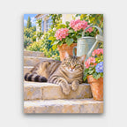 Tabby on the Garden Steps paint by numbers kit of a tabby cat lounging on stone garden steps beside flower pots and a watering can