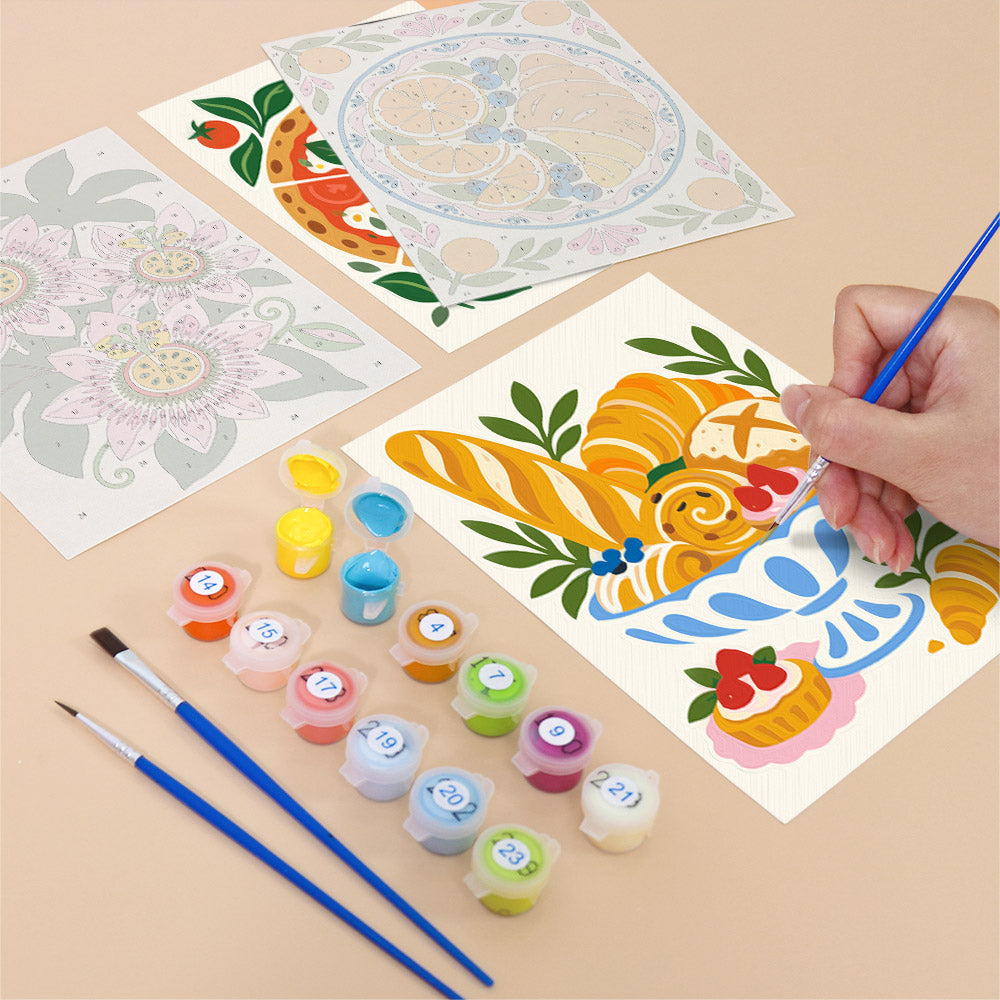 Filling in a Tablecloth Treats mini canvas with numbered acrylic paints and a fine brush