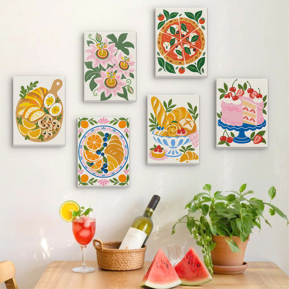 Six finished Tablecloth Treats mini paintings hung on a wall above a table