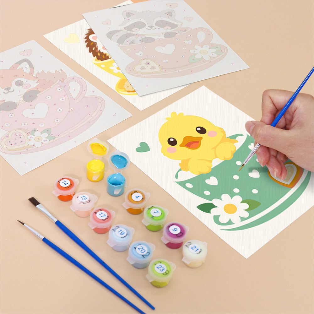 Filling in a Teacup Critters mini canvas with numbered acrylic paints and a fine brush