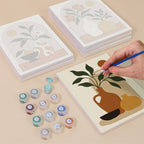 Painting one of the Terracotta Arches designs next to a stack of mini canvases