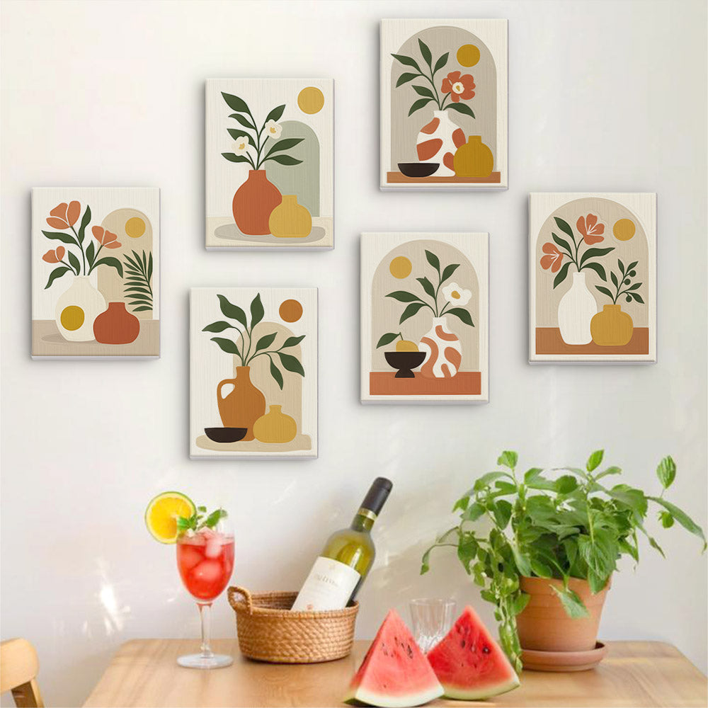 Six finished Terracotta Arches mini paintings hung on a wall above a table