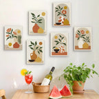 Six finished Terracotta Arches mini paintings hung on a wall above a table