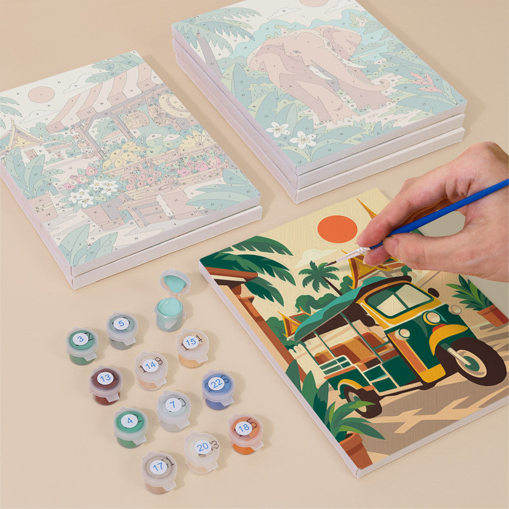 Painting one of the Thailand Escape designs next to a stack of mini canvases