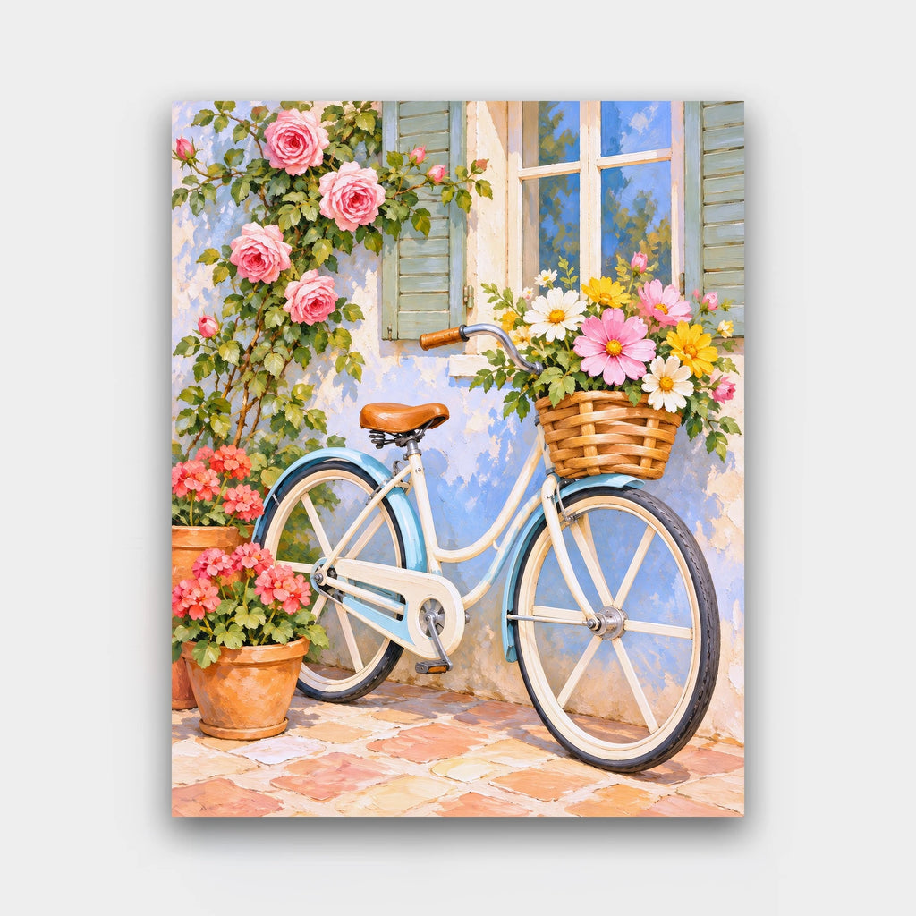 The Blue Bicycle paint by numbers kit of a pale blue bicycle with a wicker basket of wildflowers against a wall of climbing roses