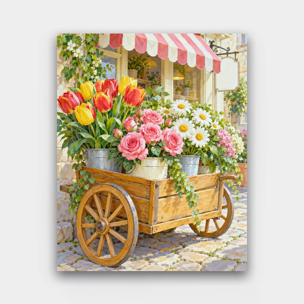 The Flower Cart paint by numbers kit of a wooden cart loaded with buckets of tulips, roses and daisies on a cobbled street