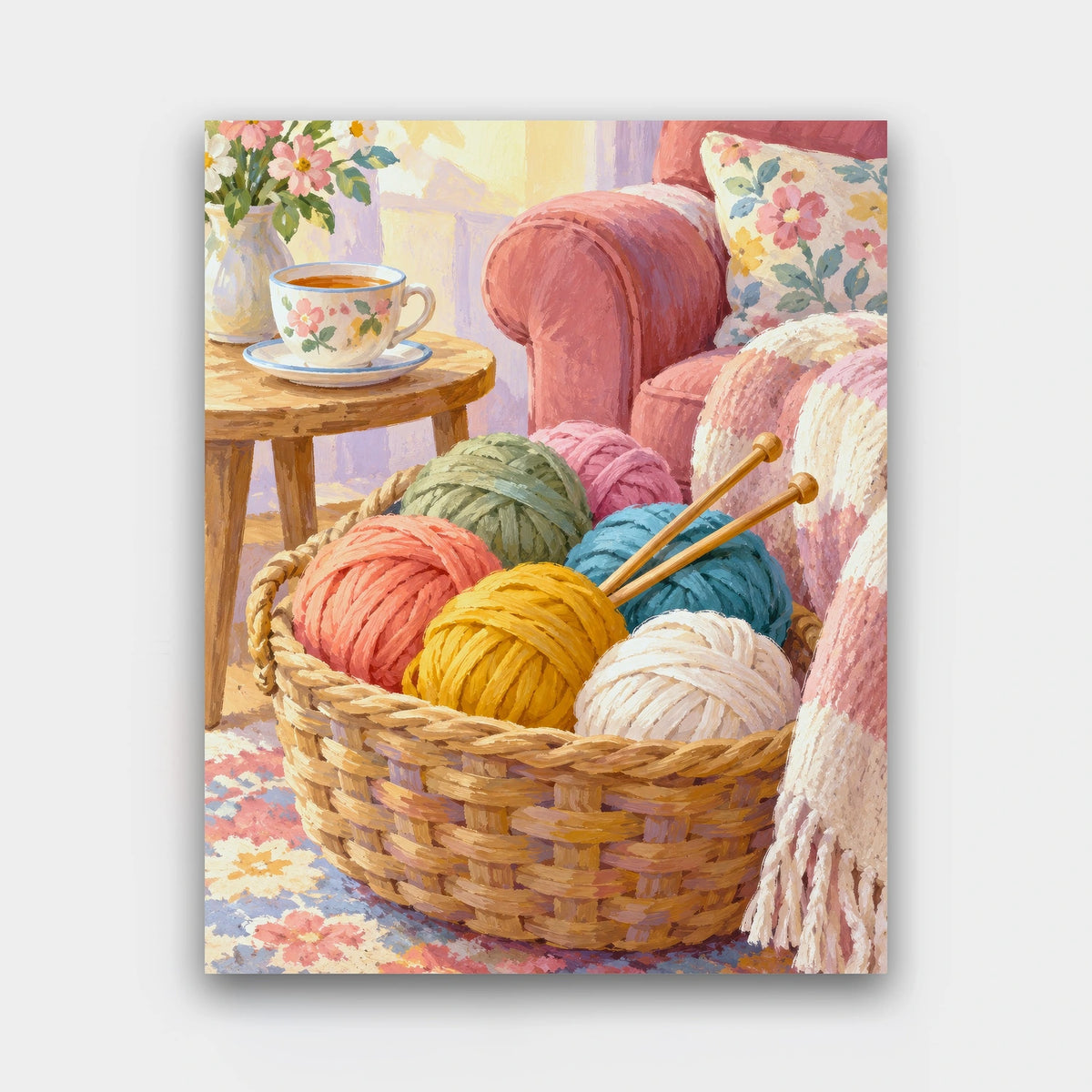 The Yarn Basket paint by numbers kit of a wicker basket of colorful yarn balls and knitting needles by a pink armchair