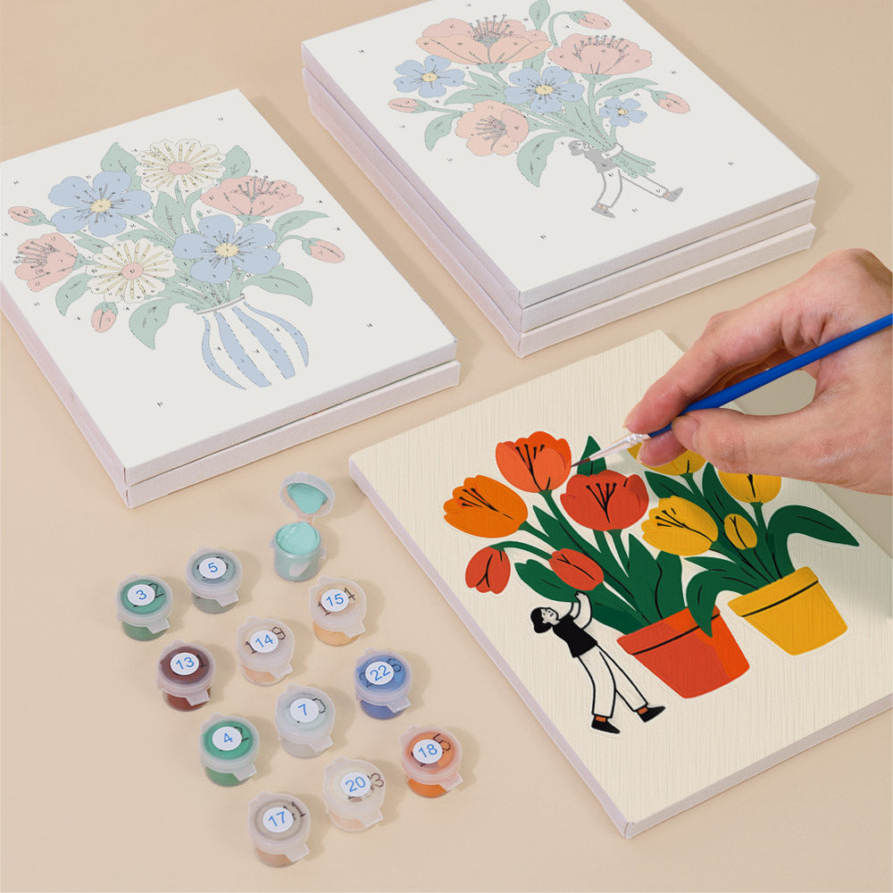 Painting one of the Tiny Gardeners designs next to a stack of mini canvases