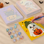 Painting one of the Tiny Trick-or-Treaters designs next to a stack of mini canvases