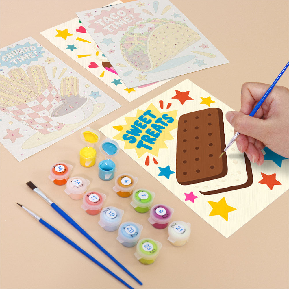 Filling in a Treat Time mini canvas with numbered acrylic paints and a fine brush