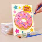 Painting a Treat Time mini canvas propped up beside numbered acrylic paints