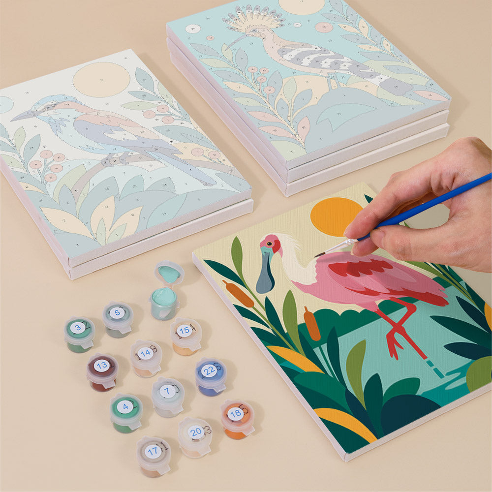 Painting one of the Tropical Birds designs next to a stack of mini canvases
