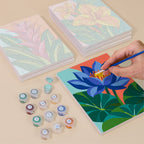 Painting one of the Tropical Blooms designs next to a stack of mini canvases