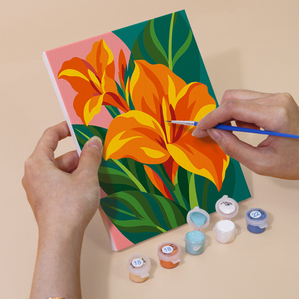 Hand holding a Tropical Blooms mini canvas while painting the details