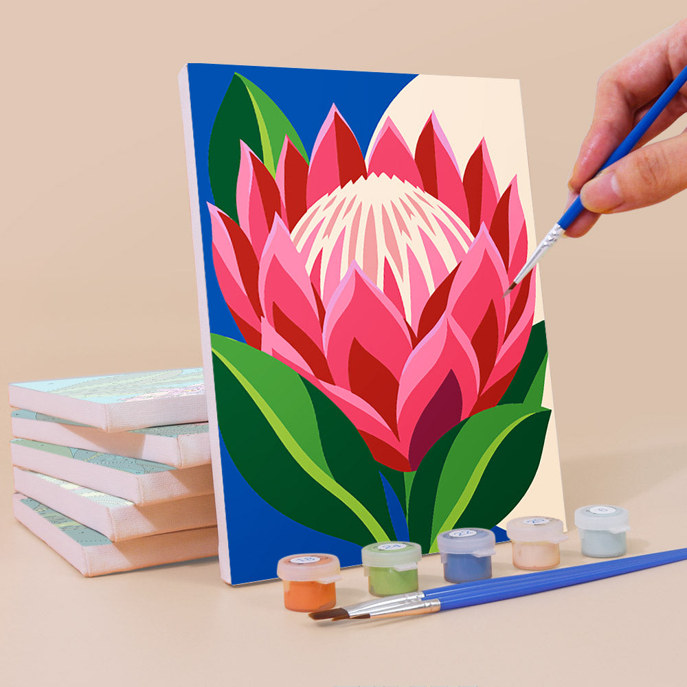 Painting a Tropical Blooms mini canvas propped up beside numbered acrylic paints