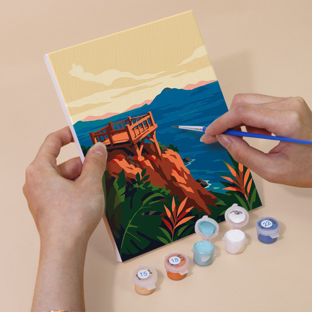 Hand holding a Tropical Coastlines mini canvas while painting the details