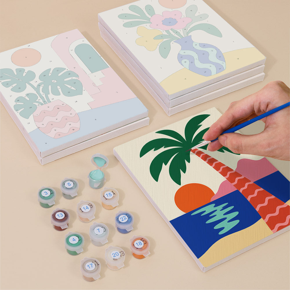 Painting one of the Tropical Cutouts designs next to a stack of mini canvases
