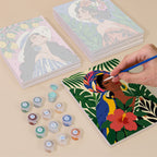 Painting one of the Tropical Muses designs next to a stack of mini canvases