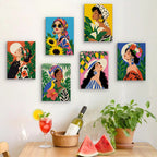 Six finished Tropical Muses mini paintings hung on a wall above a table