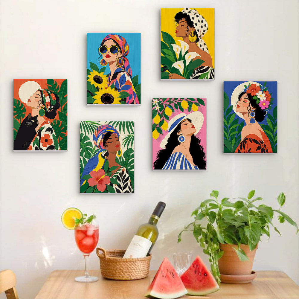 Six finished Tropical Muses mini paintings hung on a wall above a table