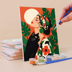 Painting a Tropical Muses mini canvas propped up beside numbered acrylic paints