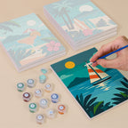 Painting one of the Tropical Sunsets designs next to a stack of mini canvases