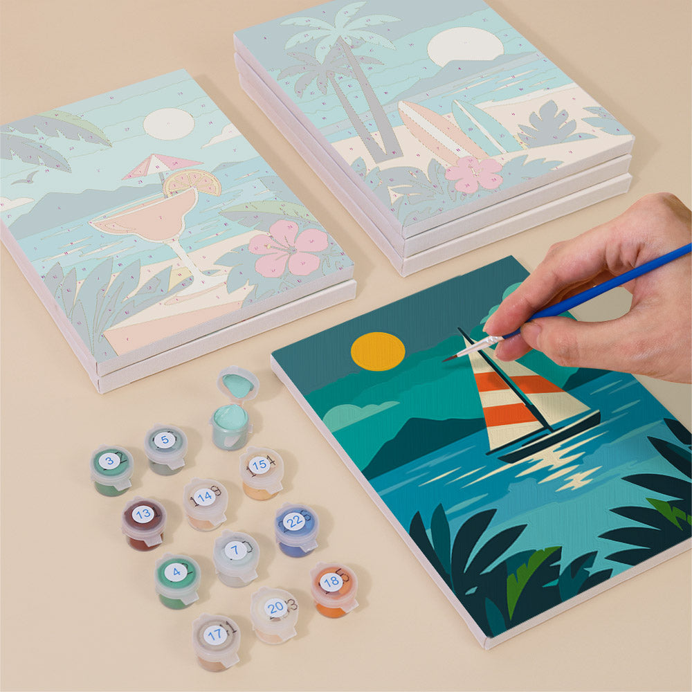 Painting one of the Tropical Sunsets designs next to a stack of mini canvases