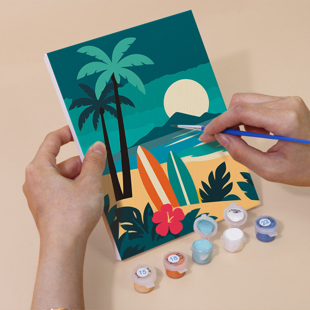 Hand holding a Tropical Sunsets mini canvas while painting the details