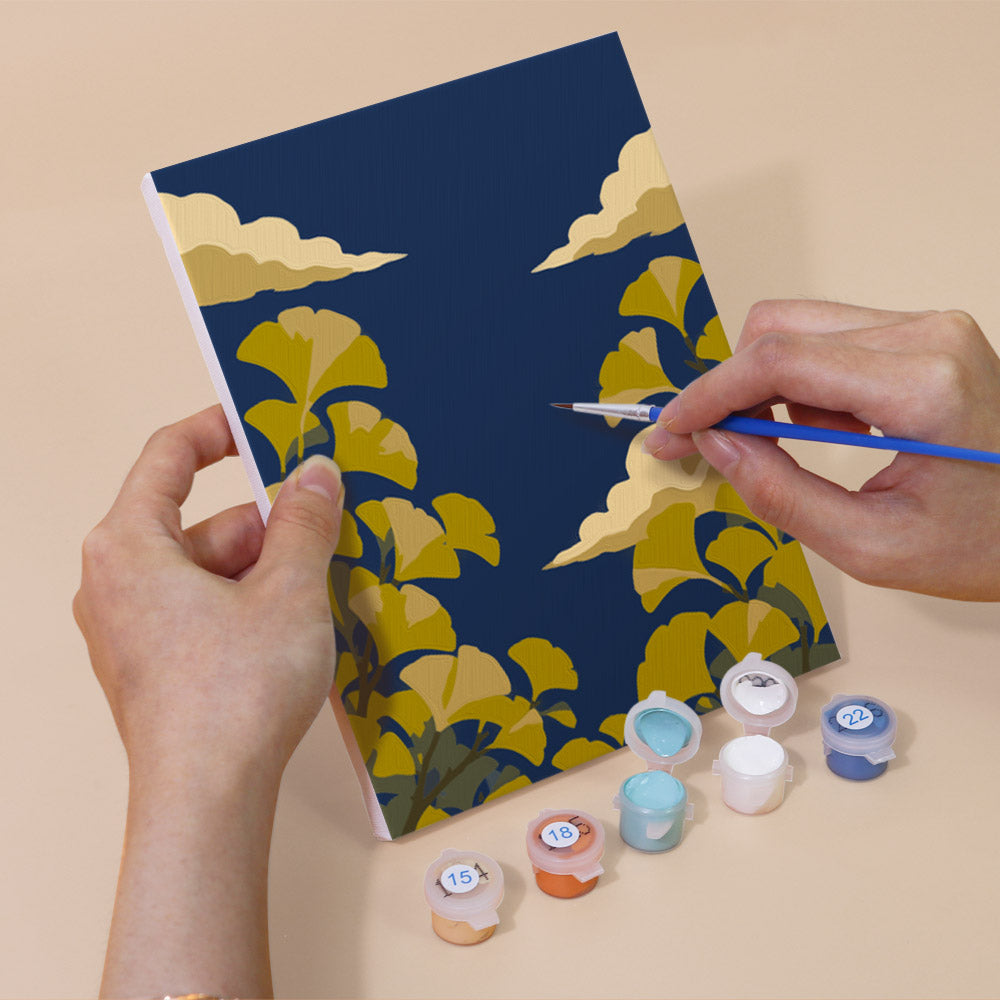 Hand holding a Twilight Meadows mini canvas while painting the details