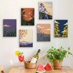 Six finished Twilight Meadows mini paintings hung on a wall above a table