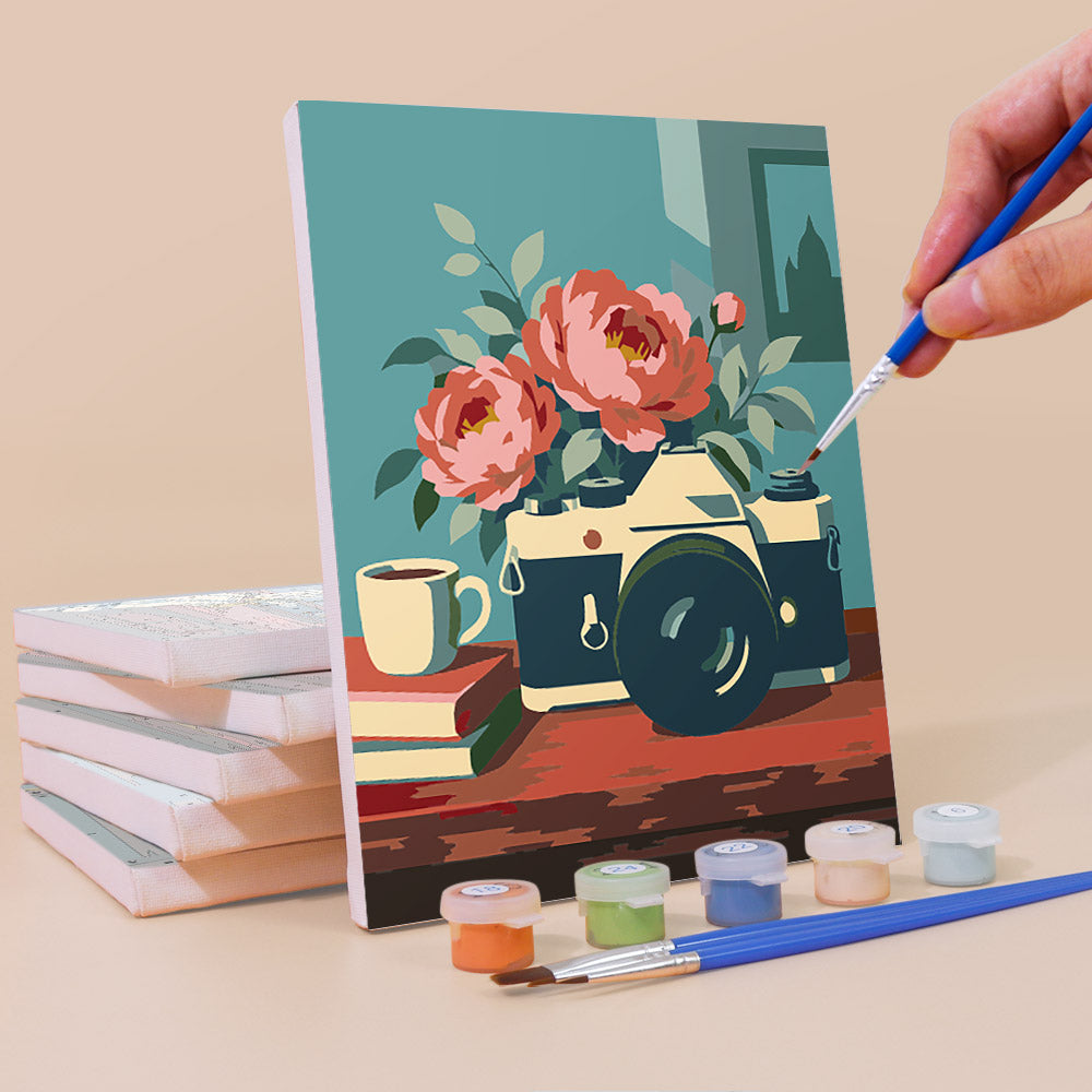 Painting a Vintage Keepsakes mini canvas propped up beside numbered acrylic paints