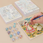 Painting one of the Vintage Romance designs next to a stack of mini canvases