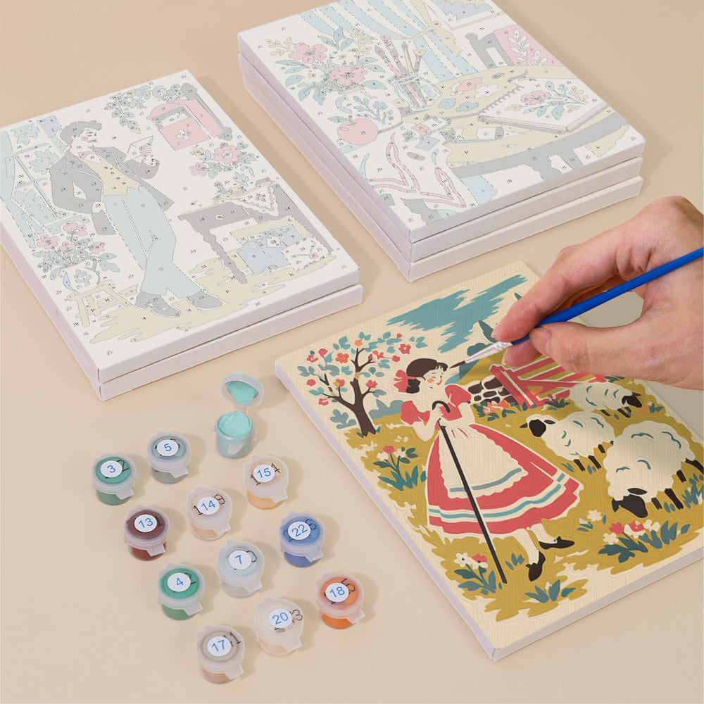Painting one of the Vintage Romance designs next to a stack of mini canvases