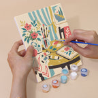 Hand holding a Vintage Romance mini canvas while painting the details