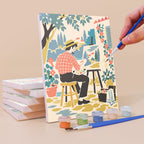 Painting a Vintage Romance mini canvas propped up beside numbered acrylic paints