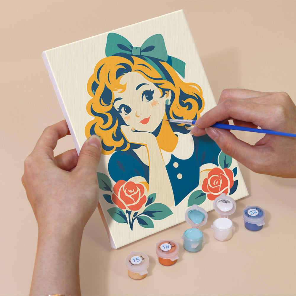 Hand holding a Vintage Sweethearts mini canvas while painting the details
