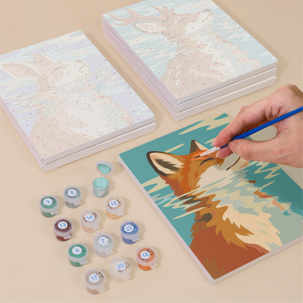 Painting one of the Water Reflections designs next to a stack of mini canvases