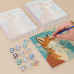 Painting one of the Water Reflections designs next to a stack of mini canvases