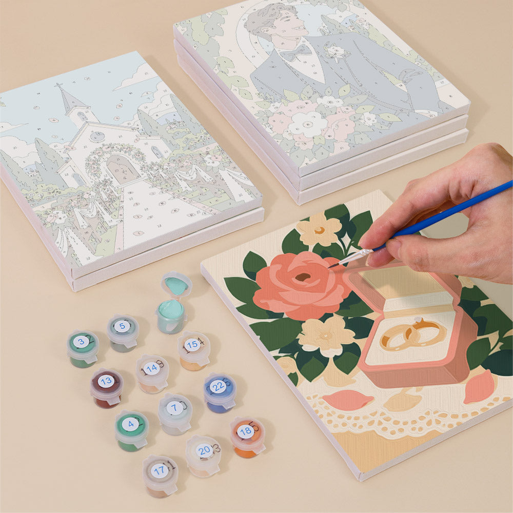 Painting one of the Wedding Day designs next to a stack of mini canvases